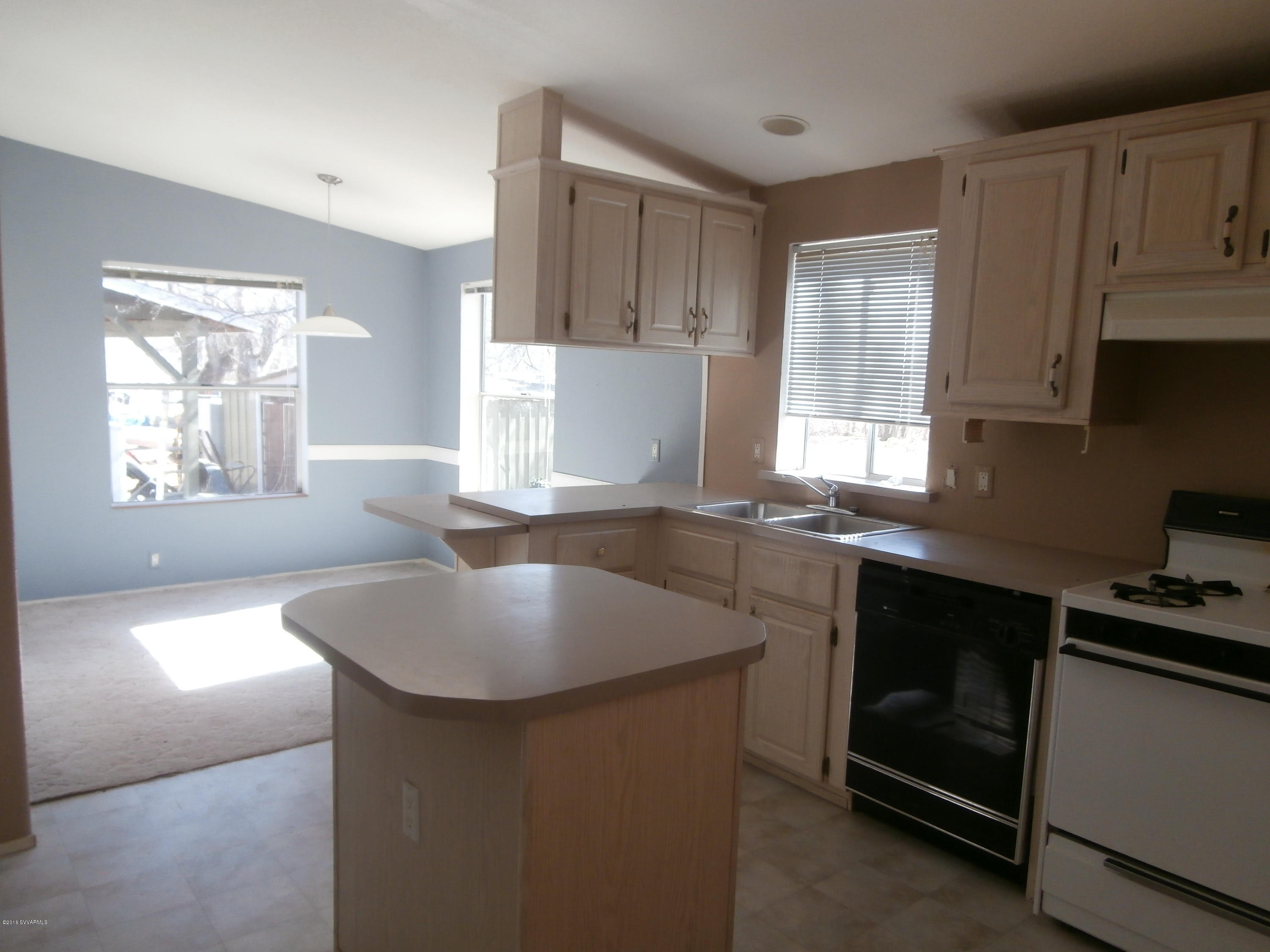 4305 East Aztec Road Rimrock, AZ 86335 - Photo 17 of 25 a kitchen with kitchen island a sink stove and cabinets