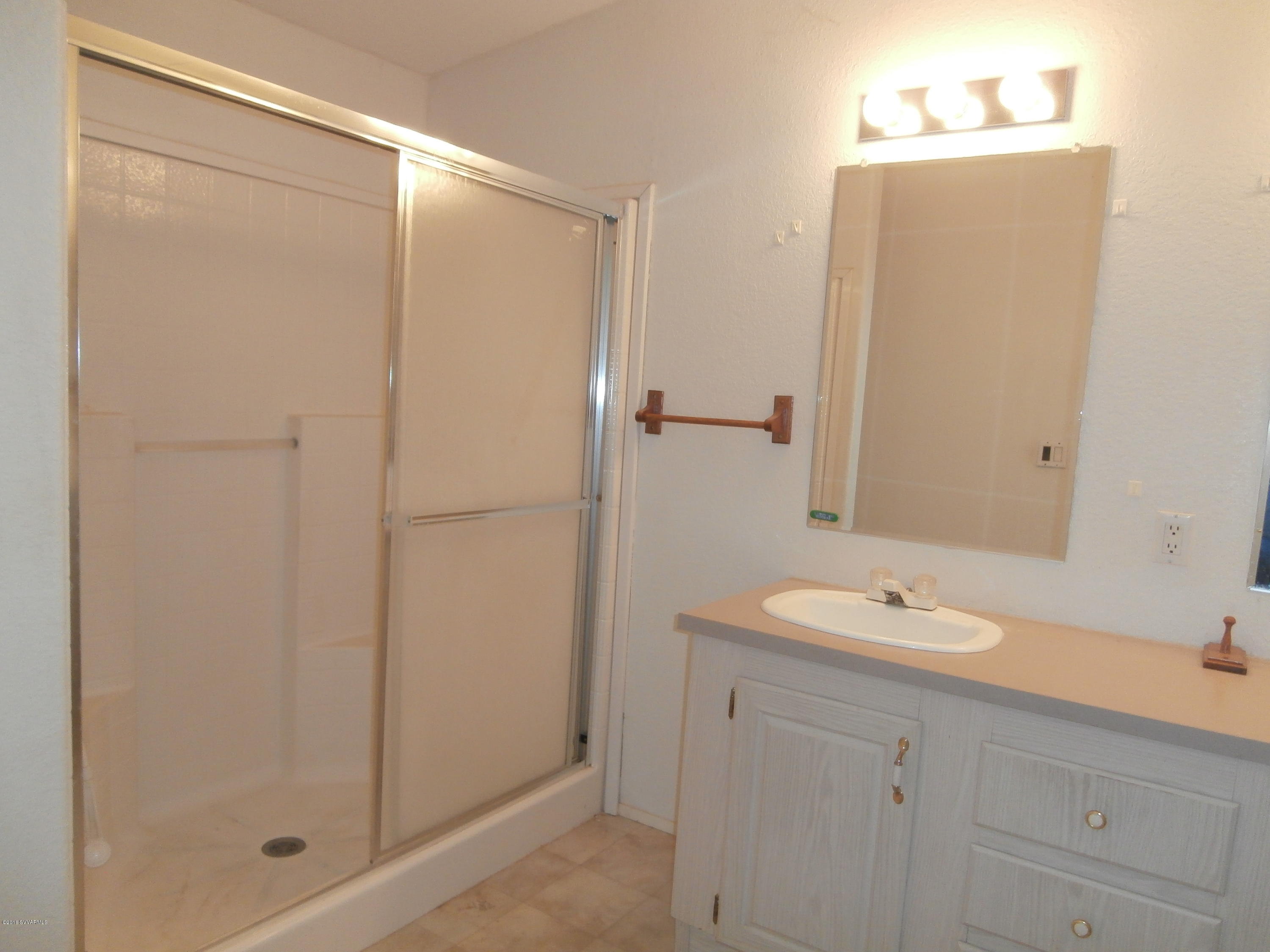 4305 East Aztec Road Rimrock, AZ 86335 - Photo 23 of 25 a bathroom with a shower sink and mirror