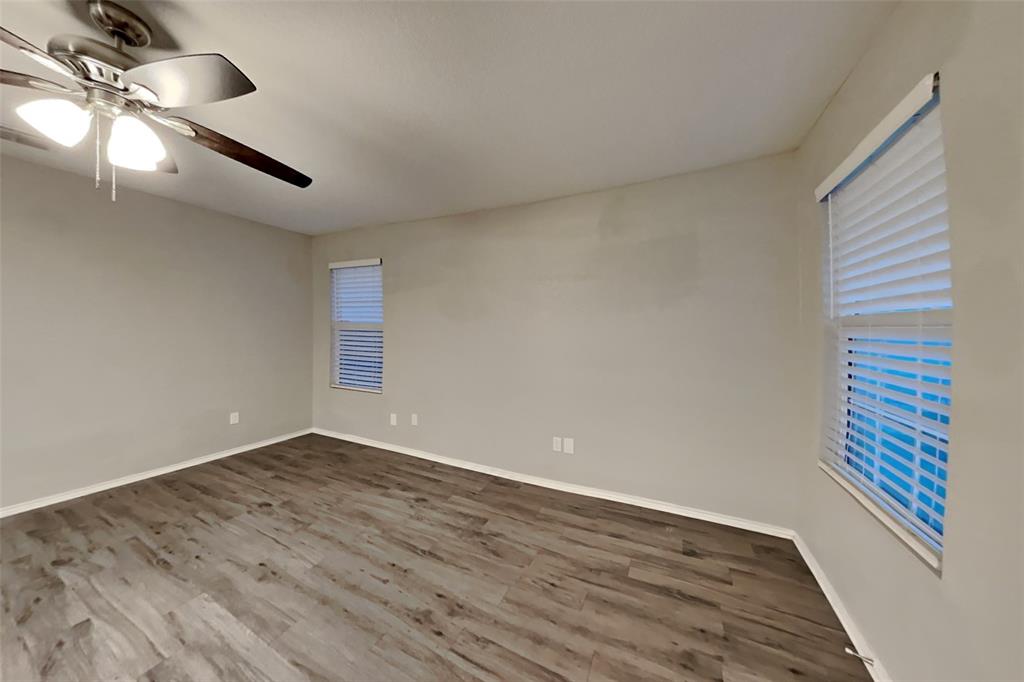 5529 McClelland Street Forney, TX 75126 - Photo 3 of 16 a view of an empty room with wooden floor and a window