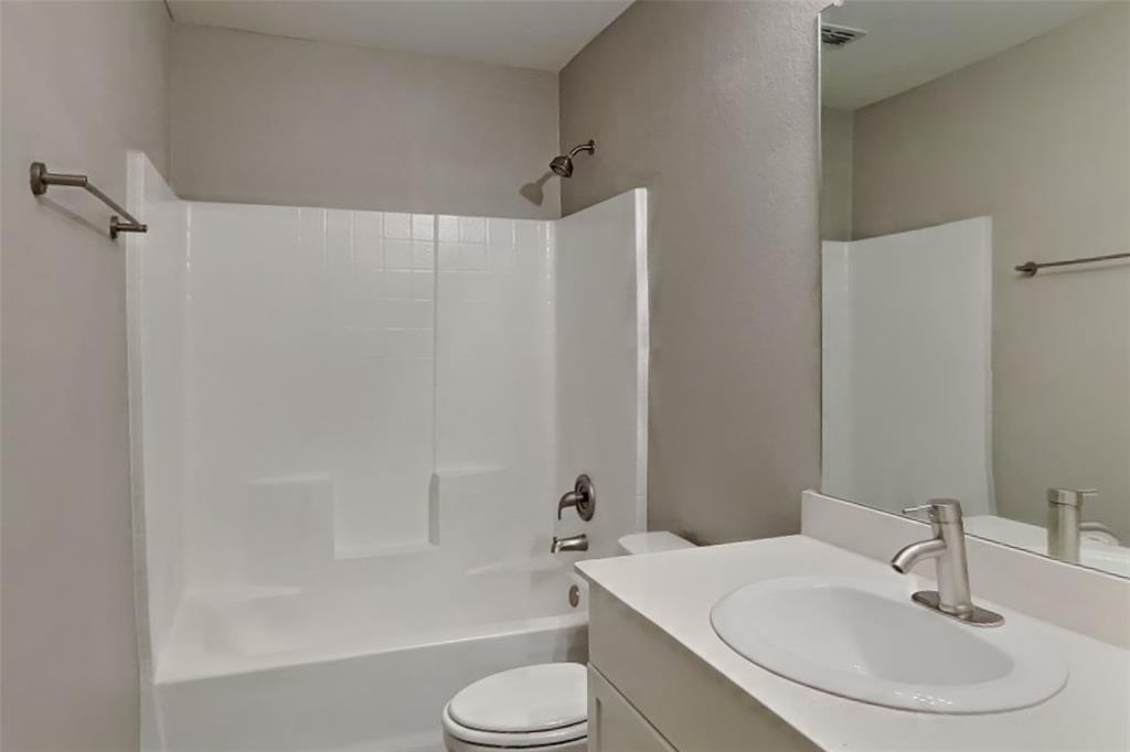 5529 McClelland Street Forney, TX 75126 - Photo 8 of 16 a bathroom with a sink toilet and shower