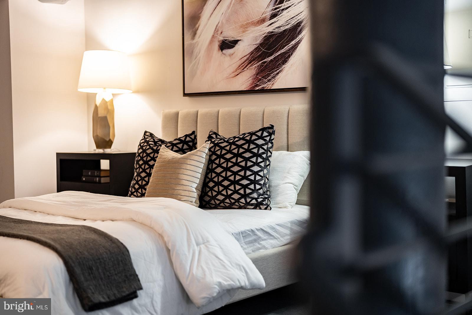 1401 R Street Northwest, Unit 406 Washington, DC 20009 - Photo 11 of 22 a bedroom with a bed and a night stand