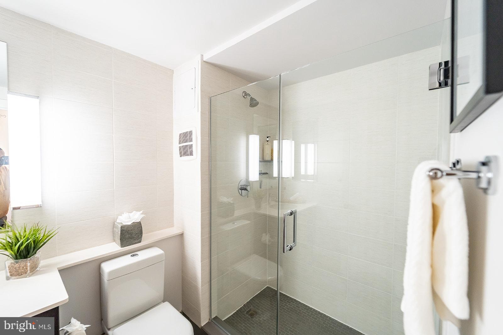 1401 R Street Northwest, Unit 406 Washington, DC 20009 - Photo 12 of 22 a bathroom with a shower toilet and sink