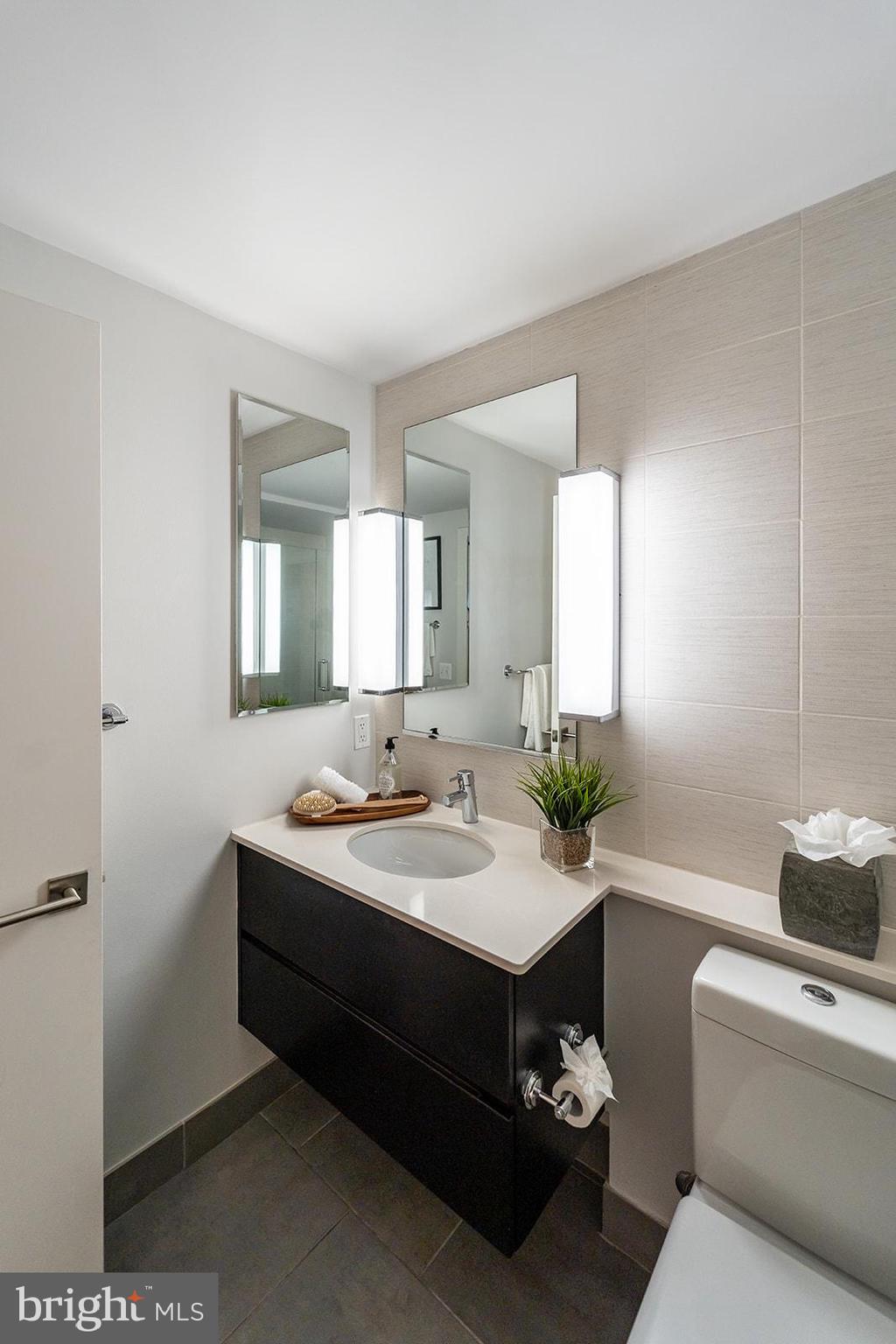 1401 R Street Northwest, Unit 406 Washington, DC 20009 - Photo 13 of 22 a bathroom with a double vanity sink and mirror