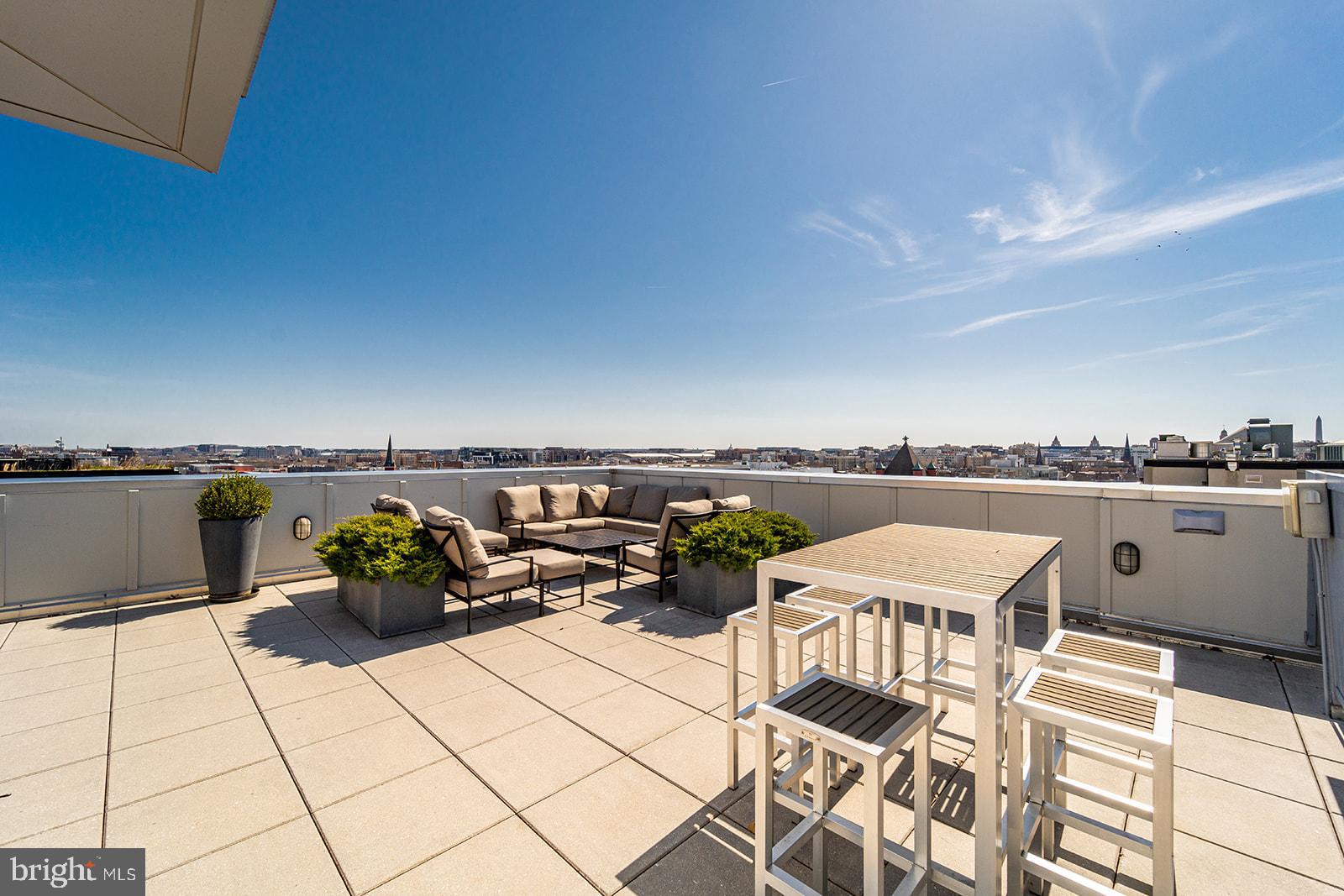 1401 R Street Northwest, Unit 406 Washington, DC 20009 - Photo 16 of 22 a terrace with outdoor seating and city view