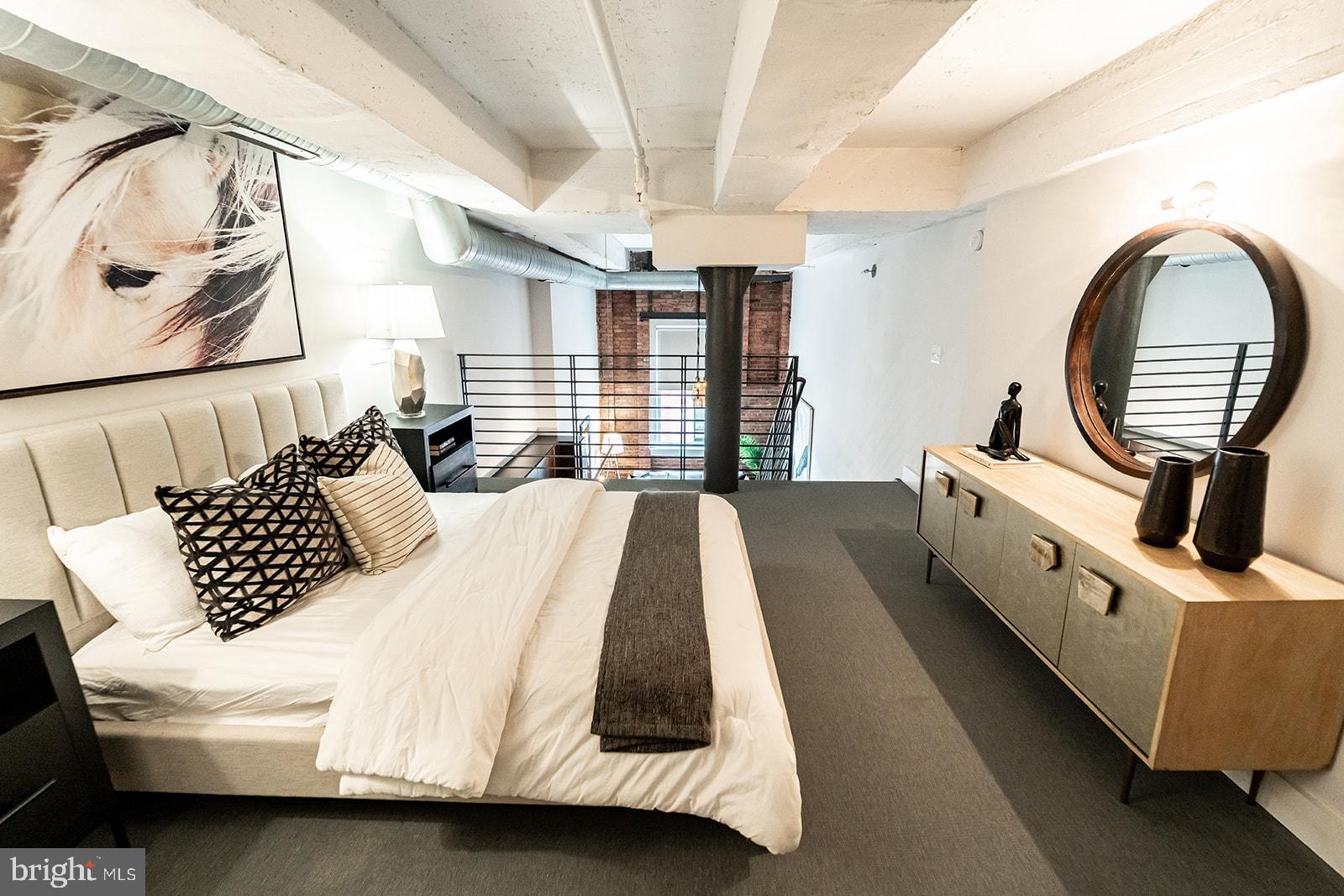 1401 R Street Northwest, Unit 406 Washington, DC 20009 - Photo 10 of 22 a large bed sitting in a bedroom next to a window