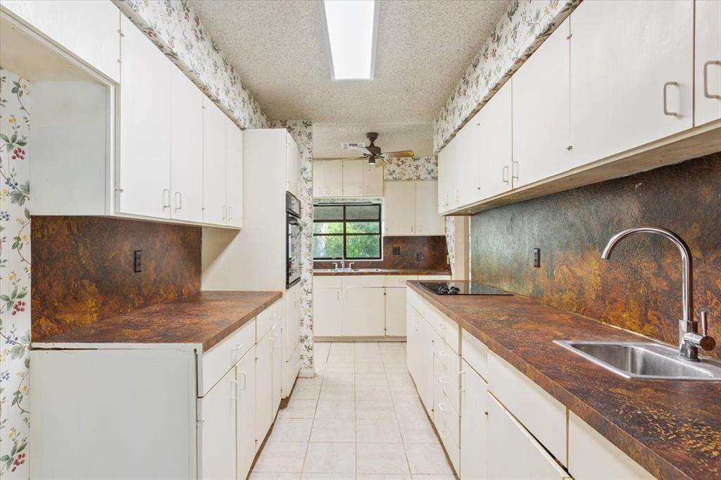 1487 Middleton Road Mart, TX 76664 - Photo 21 of 40 a kitchen with stainless steel appliances granite countertop a sink stove and cabinets