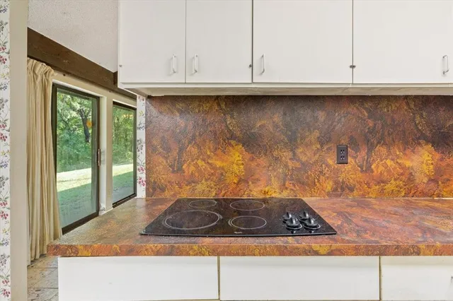 a bathroom with a granite countertop sink and a window