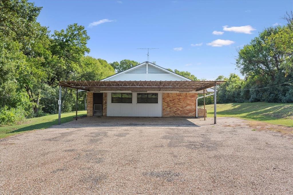 1487 Middleton Road Mart, TX 76664 - Photo 6 of 40 a front view of a house with a yard and garage