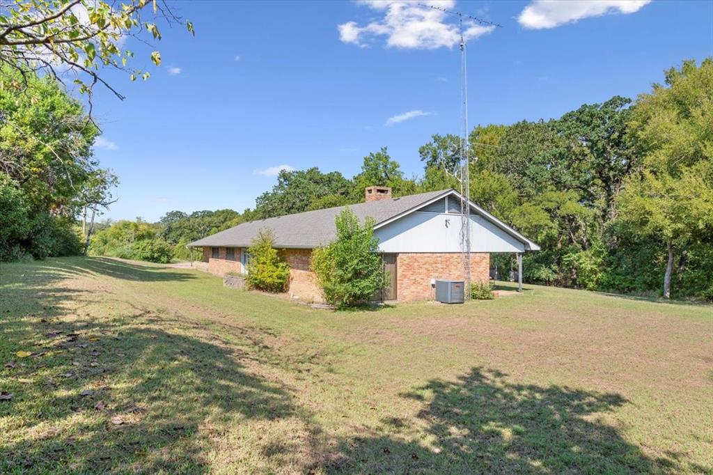 1487 Middleton Road Mart, TX 76664 - Photo 9 of 40 a big house with a big yard and large trees