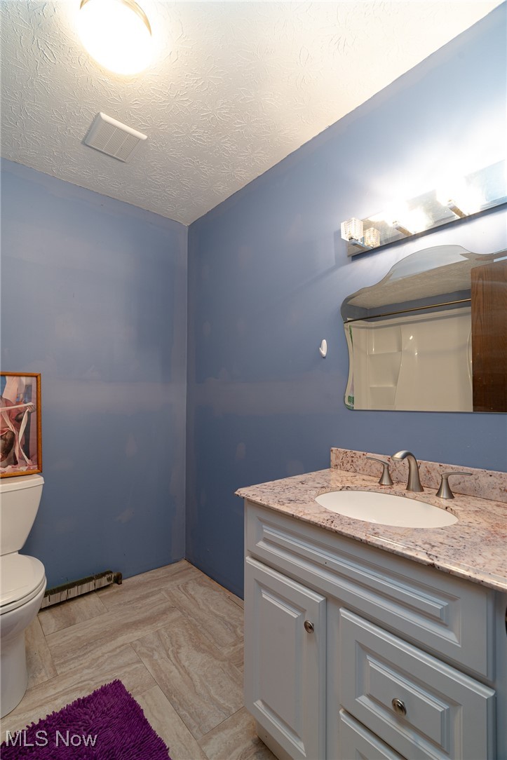6747 Giddings Road Rootstown, OH 44272 - Photo 19 of 39 Full hallway bath featuring a newer vanity and toilet