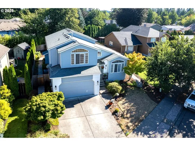 a view of a house with a yard and garden