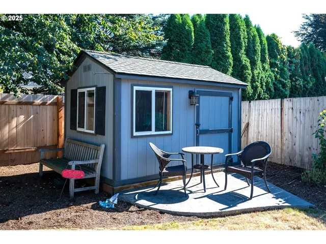 a backyard of a house with table and chairs