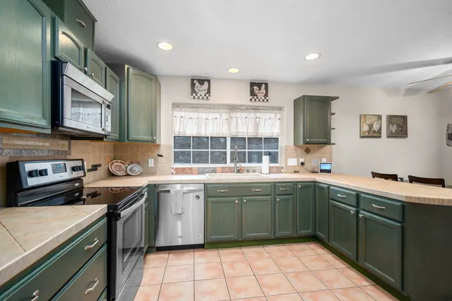 a kitchen with a sink appliances and cabinets