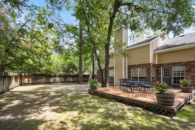 a view of a house with backyard porch and sitting area