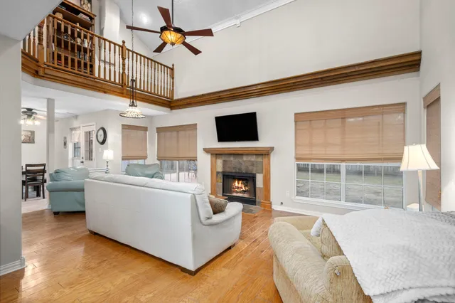 a living room with furniture a fireplace and a large window