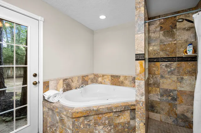 a bathroom with a tub and shower