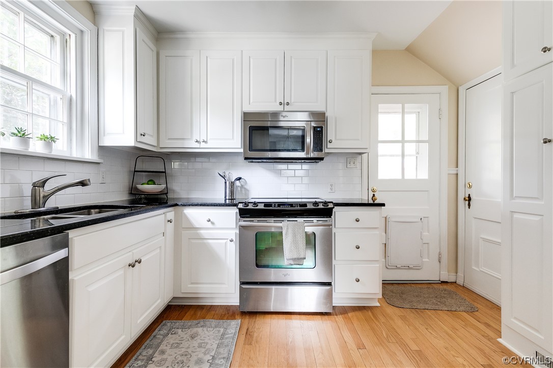 5115 Sylvan Road Richmond, VA 23225 - Photo 23 of 37 a kitchen with stainless steel appliances granite countertop a stove a sink and a microwave