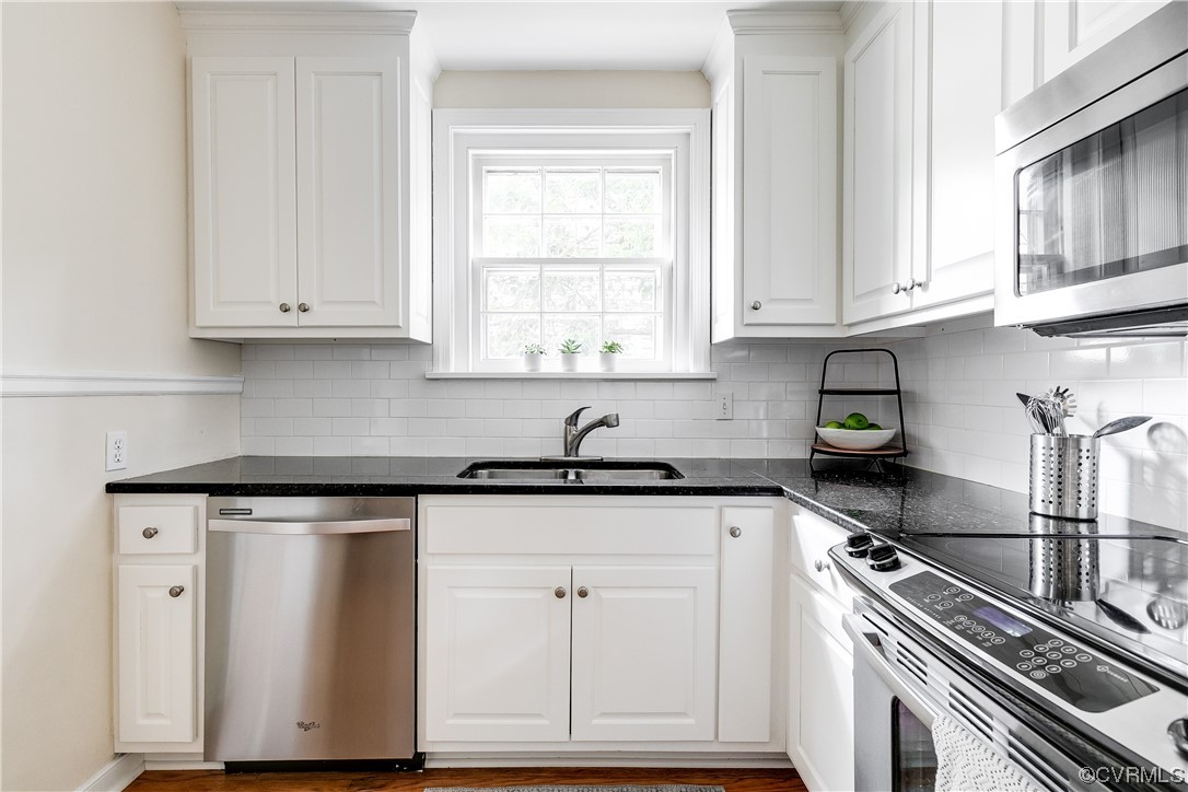 5115 Sylvan Road Richmond, VA 23225 - Photo 24 of 37 a kitchen with stainless steel appliances granite countertop a sink stove and cabinets
