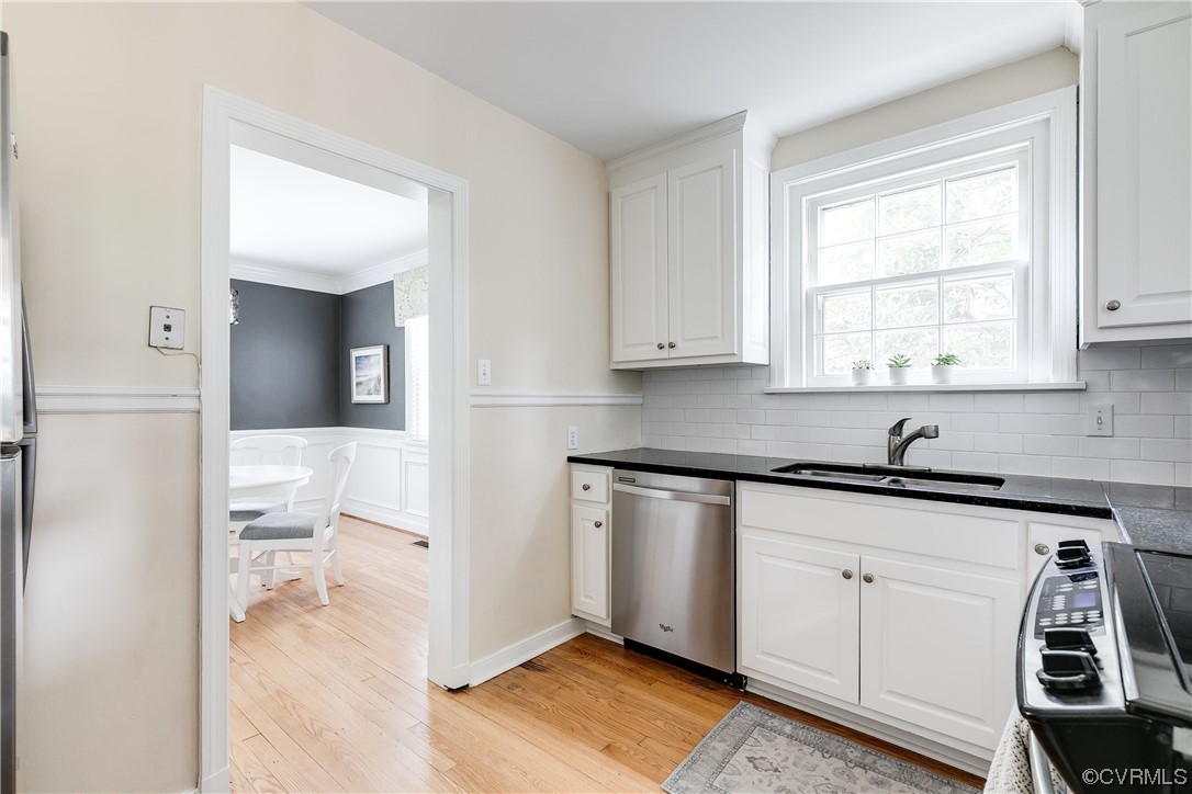 5115 Sylvan Road Richmond, VA 23225 - Photo 25 of 37 a kitchen with white cabinets and a window