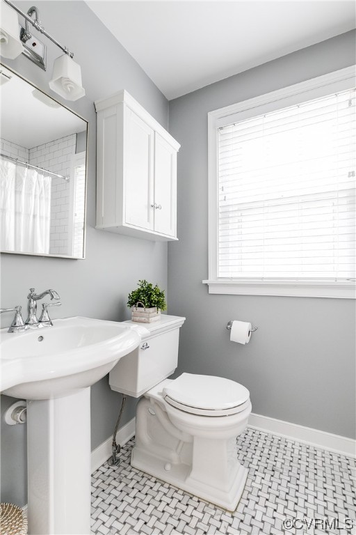 5115 Sylvan Road Richmond, VA 23225 - Photo 27 of 37 a bathroom with a sink a toilet and a window