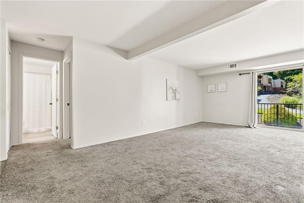 551 Sloop Road, Unit 67 Pittsburgh, PA 15237 - Photo 13 of 39 View of living room looking down the hall to the bath. Primary on right.