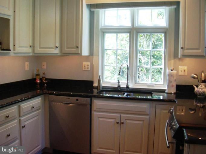 7102 Sheffield Road Baltimore, MD 21212 - Photo 14 of 22 a kitchen with granite countertop a sink window and cabinets