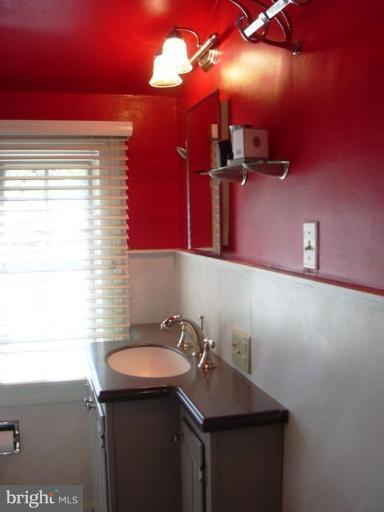 7102 Sheffield Road Baltimore, MD 21212 - Photo 22 of 22 a bathroom with a sink and a mirror