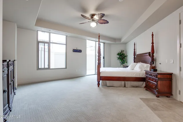 a bed room with a bed and a potted plant