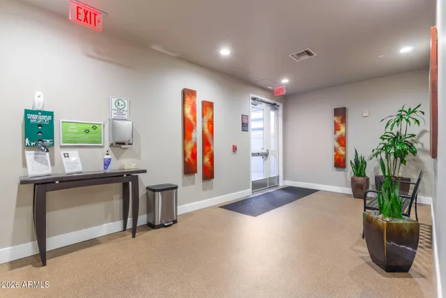 a living room with furniture and potted plants