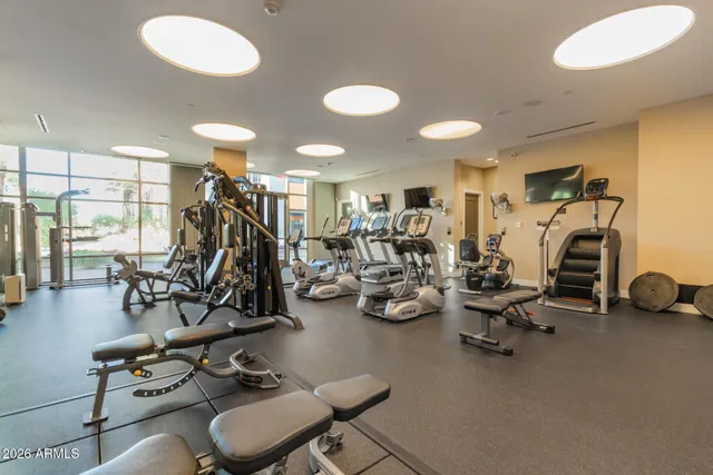 a swimming pool with outdoor seating and city view