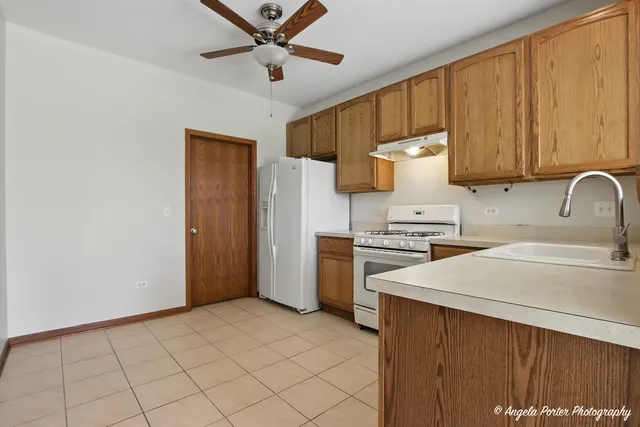 a kitchen with a refrigerator and a sink