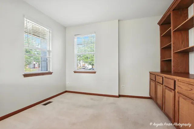 a room with a window and a dresser