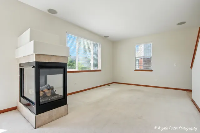 an empty room with windows and closet