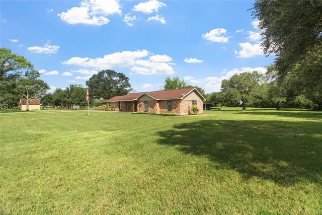a view of a big yard with swimming pool and outdoor seating