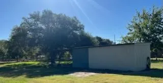 a kitchen with granite countertop a sink and a stove next to a blue wall
