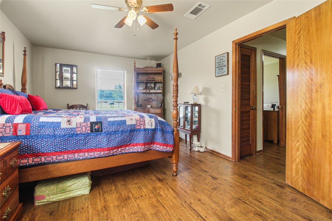 10704 Buls Road East Bernard, TX 77435 - Photo 31 of 49 a bedroom with bed and wooden floor
