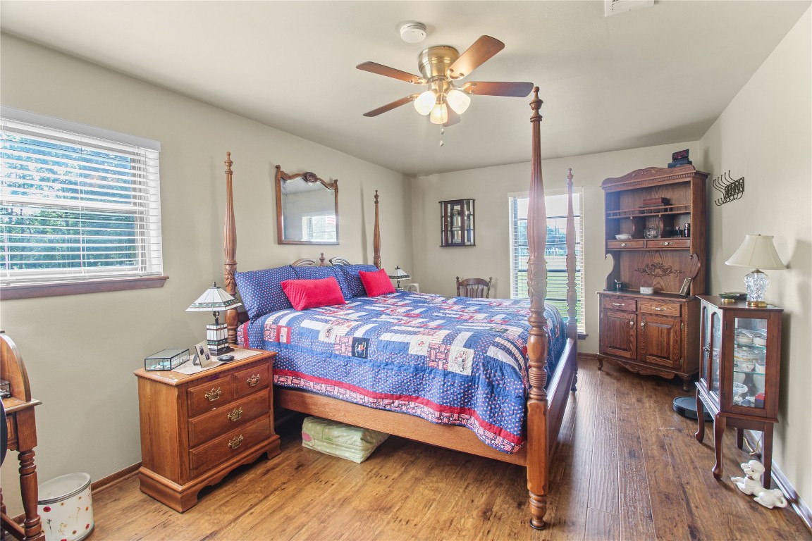 10704 Buls Road East Bernard, TX 77435 - Photo 32 of 49 a bedroom with a bed and a chandelier
