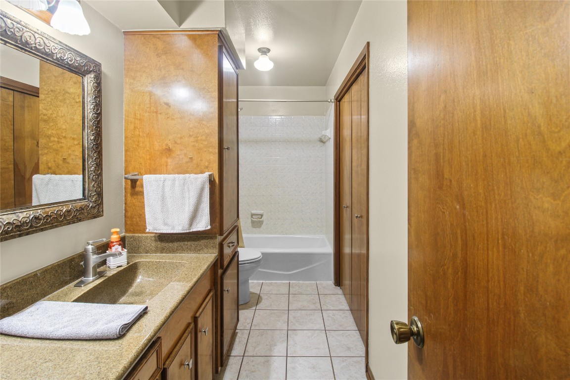 10704 Buls Road East Bernard, TX 77435 - Photo 34 of 49 a bathroom with a granite countertop sink and a mirror