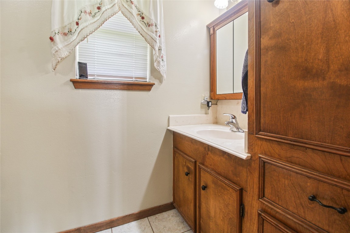 10704 Buls Road East Bernard, TX 77435 - Photo 38 of 49 a bathroom with a sink a mirror and a window