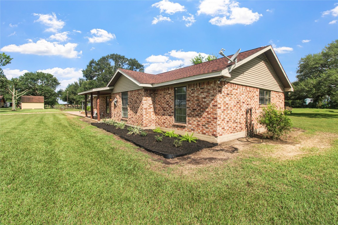 10704 Buls Road East Bernard, TX 77435 - Photo 4 of 49 a front view of a house with garden
