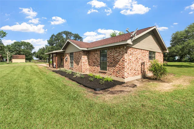 a front view of house with yard and green space