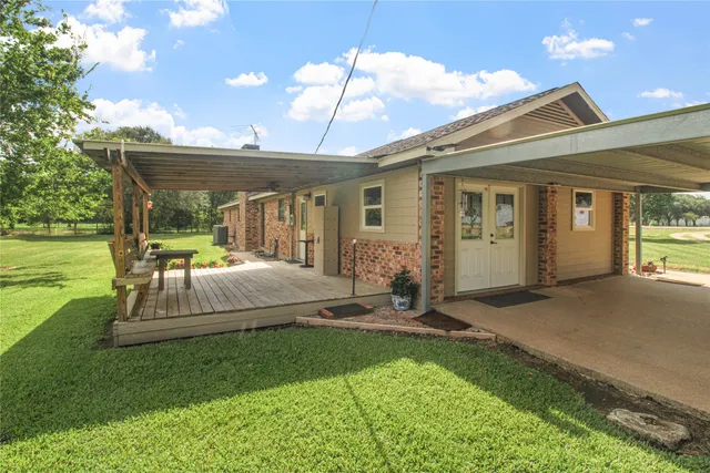a backyard of a house with table and chairs