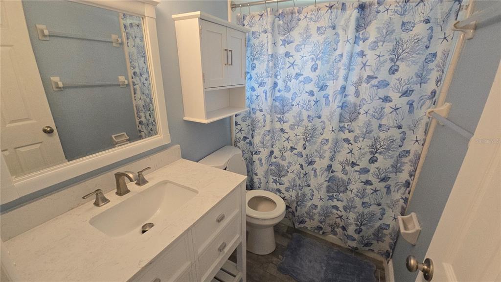 3755 South School Avenue, Unit 42 Sarasota, FL 34239 - Photo 16 of 22 a bathroom with a sink and mirror with toilet