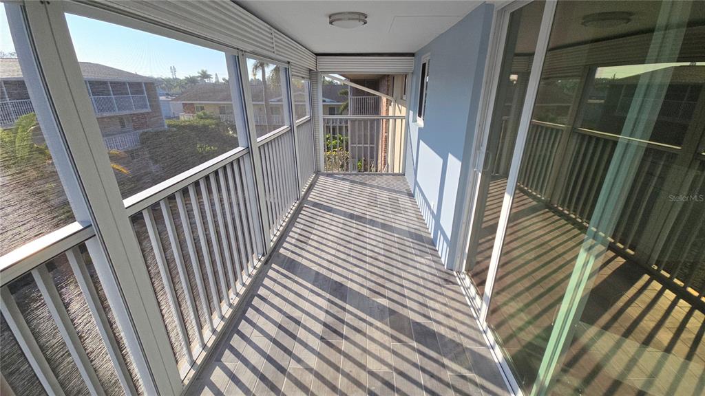 3755 South School Avenue, Unit 42 Sarasota, FL 34239 - Photo 18 of 22 a view of a balcony with wooden floor