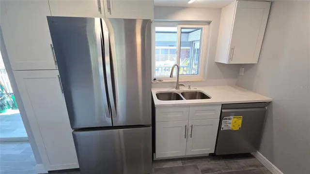 a kitchen with a refrigerator and a sink