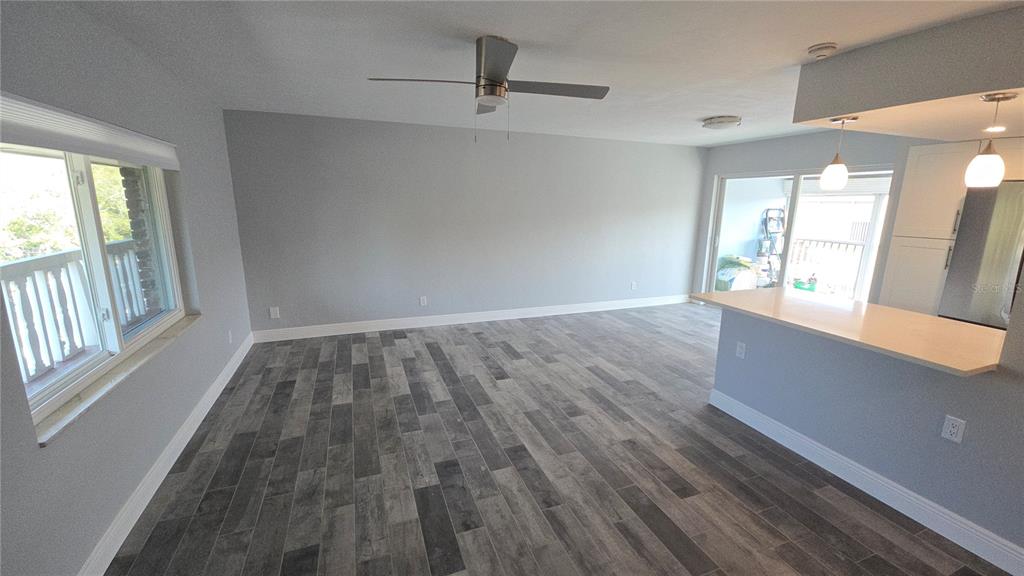 3755 South School Avenue, Unit 42 Sarasota, FL 34239 - Photo 10 of 22 an empty room with wooden floor and windows