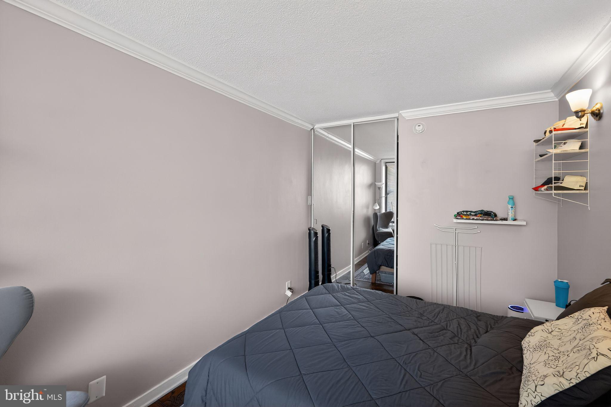 429 N Street Southwest, Unit S210 Washington, DC 20024 - Photo 12 of 16 a bedroom with a bed and a refrigerator