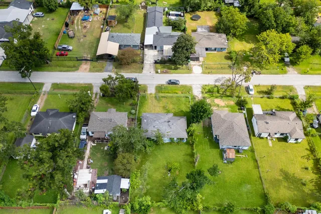 an aerial view of residential houses with outdoor space and swimming pool