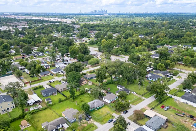 a view of a city with lush green forest