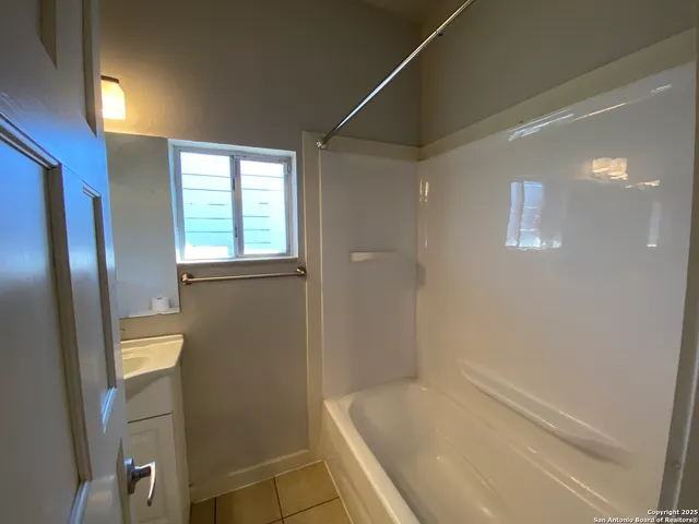 a bathroom with a bathtub and shower